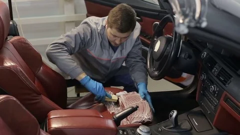 Dry cleaning of a cabriolet .Master cleans car seats.Two shot Stock Footage 76355326