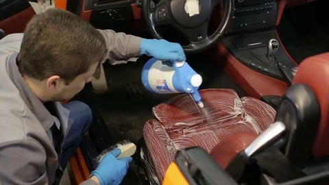 Dry cleaning of a cabriolet .Master cleans car seats.Two shot Stock-Footage 76355626