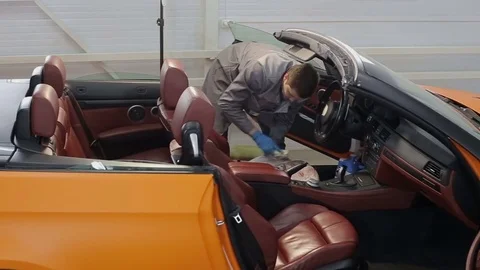 Dry cleaning of a cabriolet .Master cleans car seats.Two shot Stock Footage 76355957