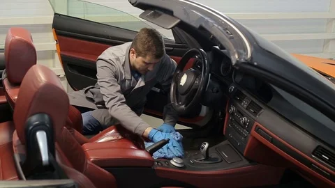 Dry cleaning of a cabriolet .Master cleans car seats. Stock Footage 76356157