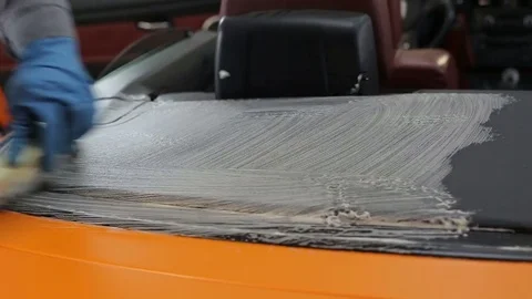 Dry cleaning of a cabriolet .Master cleans the rear of the body.Two shot Stock-Footage 76357001