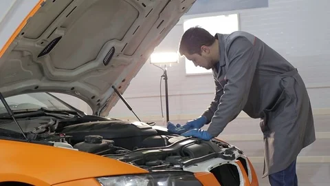Dry cleaning of a cabriolet .Master cleans the front of the body.two shot Stock Footage 76357321
