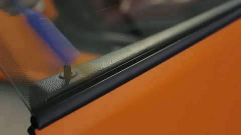 Dry cleaning of a cabriolet .Master with a fine brush cleans the car door. Stock-Footage 76354925