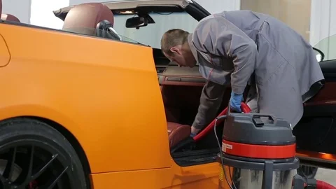 Dry cleaning of a cabriolet .The Master vacuum cleaner car interior.Two shot Stock Footage 76353002