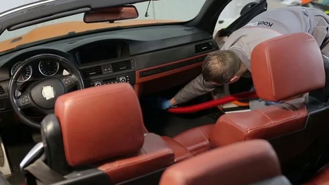 Dry cleaning of a cabriolet .The Master vacuum cleaner car interior. Stock Footage 76353211
