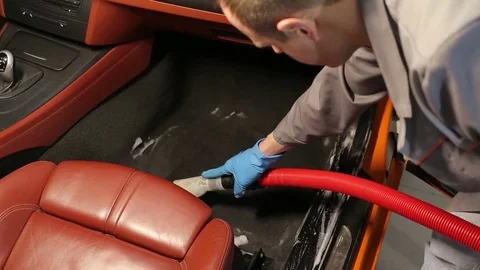 Dry cleaning of a cabriolet .The Master vacuum cleaner car interior.Two shot Stock Footage 76354397
