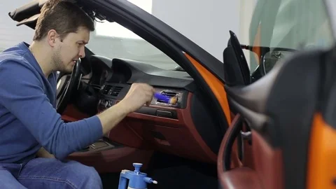 Dry cleaning of a cabriolet .The Worker cleans the car interior:Two shot Stock-Footage 76355037