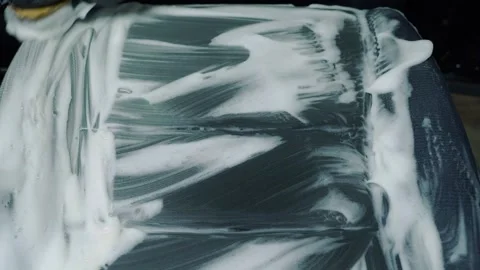 Dry cleaning of the car interior. A worker removes dirt from the seat Video stock 237100673