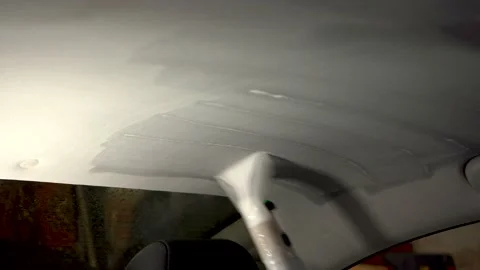 Dry cleaning of the inner lining of the car cabin with a vacuum cleaner. The Stock Footage 133988391