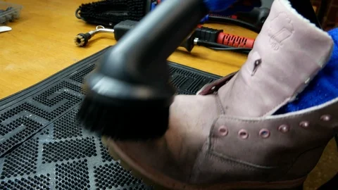 Dry cleaning shoes when using steam Stock Footage 123690357