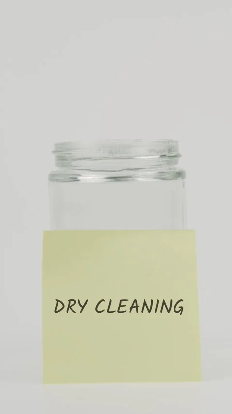Dry cleaning text or word on yellow sticky note attached to glass jar with Stock Footage 311722292