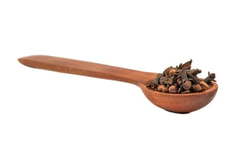 Dry cloves in spoon Stock Photos