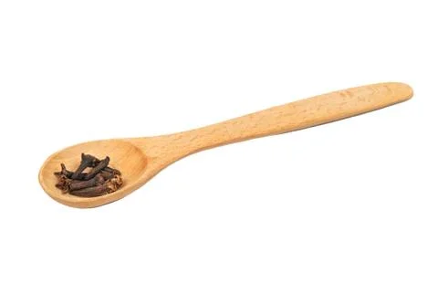 Dry cloves in spoon Stock Photos