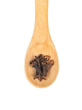 Dry cloves in spoon Stock Photos