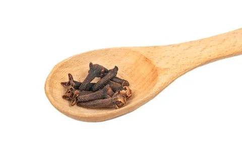 Dry cloves in spoon Stock Photos