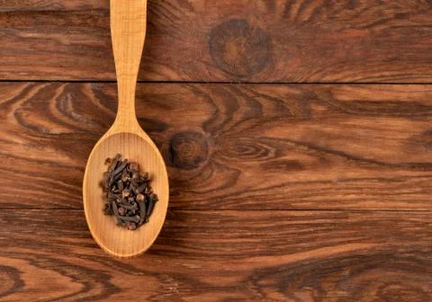 Dry cloves in spoon Stock Photos