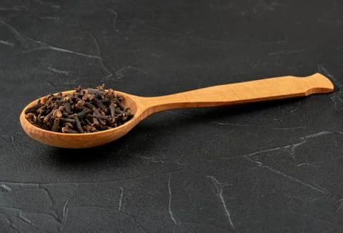 Dry cloves in spoon Stock Photos