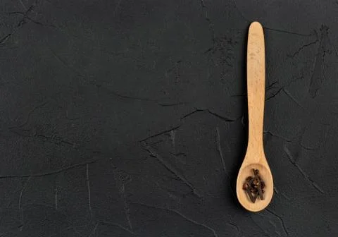 Dry cloves in spoon Stock Photos