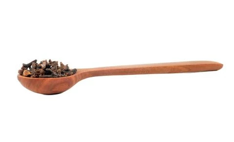 Dry cloves in spoon Stock Photos