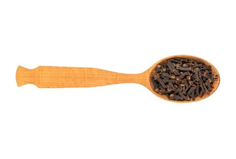 Dry cloves in spoon Stock Photos