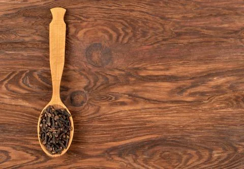 Dry cloves in spoon Stock Photos