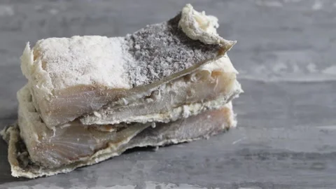 Dry cod fish on ceramic background Stock Footage 131078818