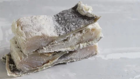 Dry cod fish on ceramic background Stock Footage 131078830