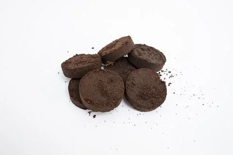 Dry coffee puck from espresso machine, isolated on white background, soft f.. Stock Photos
