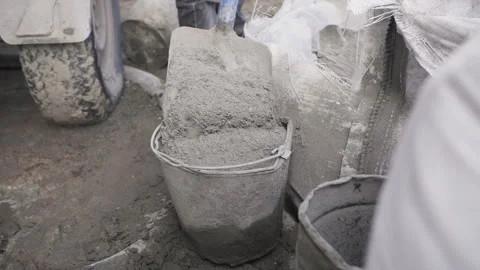 Dry concrete solution is poured into the bucket Stock Footage 238684009