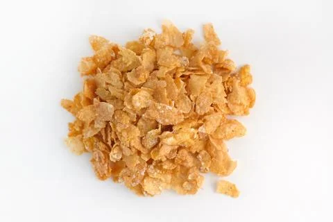 Dry corn flakes top view. Thin cornflakes in glaze on a white background. Stock-Fotos