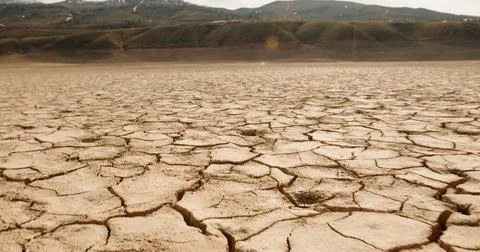 Dry cracked earth as a background close-up. Environmental disaster.Land with dry Stock Photos