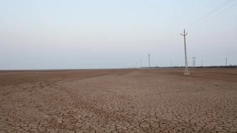 Dry cracked farm fields with bright sky at morning Video stock 300775674