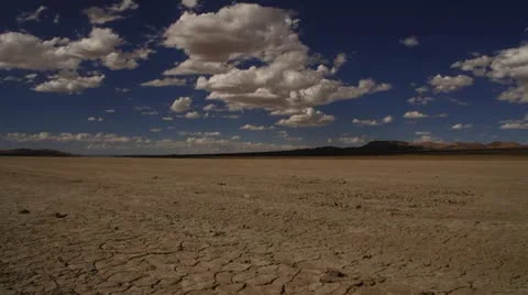 Dry cracking desert ground with clouds and dolly sliding shot.mp Stock Footage 18940676