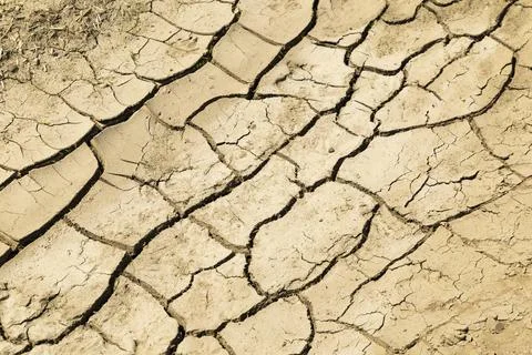 Dry cracking soil pattern representing drought and climate change Stock Photos