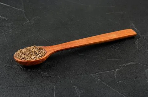 Dry cumin in spoon Stock Photos
