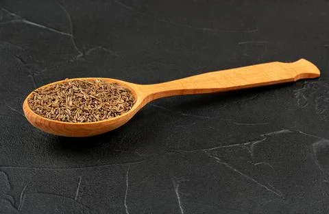 Dry cumin in spoon Stock Photos