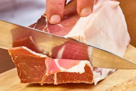 Dry cured ham thinly sliced Closeup on chef hands slices prosciutto Italian Stock Photos