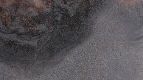 Dry dark soil and mud cracked by severe drought on earth surface, aerial Stock Footage 145569203