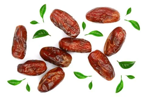 Dry dates decorated with leaves isolated on white background. Top view. Flat lay Stock Photos
