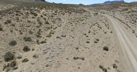 Dry, desertic, mointainous landscape. High visual of landscape with dirt road. 스톡 동영상 63606069