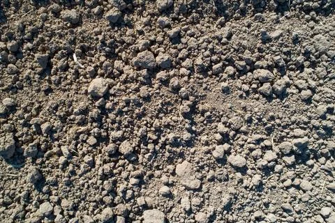 Dry earth texture with visible clumps and cracks Stock Photos