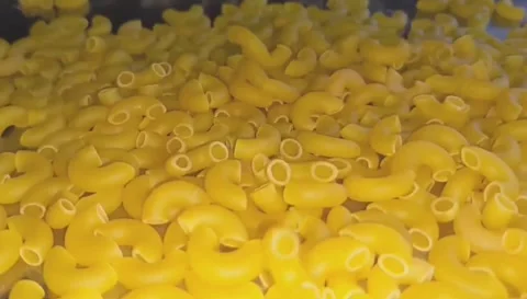 Dry Elbow Macaroni Pasta Rotating Yellow Food Clip Video stock 331764568