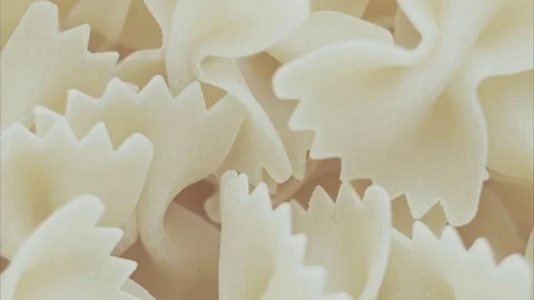 Dry farfalle pasta pattern in macro top view Video stock 81801571