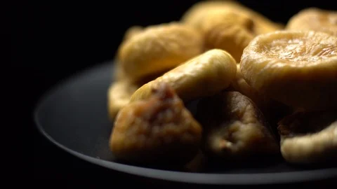 Dry figs. Close-up.  Pile of dried fruits in rotation on black background. Stock Footage 100709675