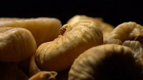 Dry figs. Close-up.  Pile of dried fruits in rotation on black background. Stock Footage 100710198