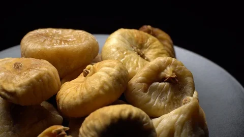 Dry figs. Close-up.  Pile of dried fruits in rotation on black background. Stock Footage 100710609