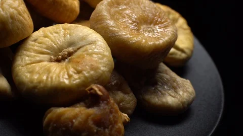 Dry figs. Close-up.  Pile of dried fruits in rotation on black background. Stock Footage 100711069