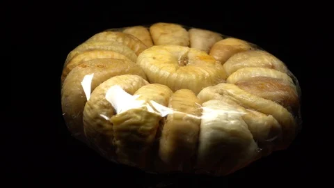 Dry figs packed in the original transparent plastic foil in rotation Stock Footage 99558372