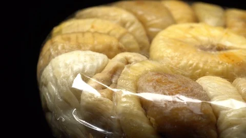 Dry figs packed in the original transparent plastic foil in rotation Stock Footage 99558384