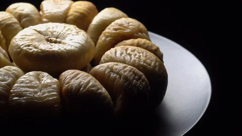 Dry figs in rotation on black background. Stock Footage 99559160